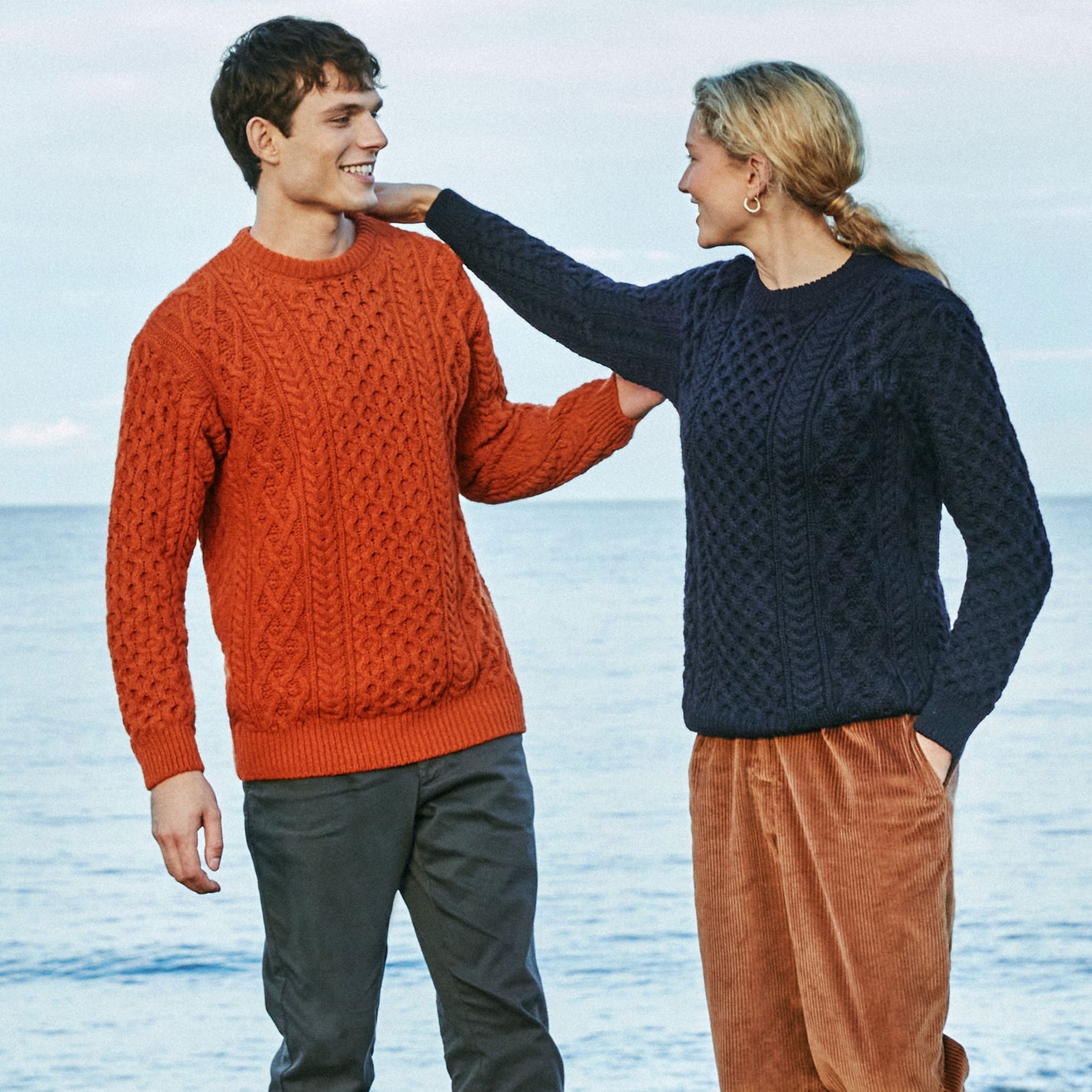 IrelandsEye Knitwear Blasket Honeycomb-Stitch-Aran-Sweater-in-Navy-Merino-and Carraig_-Luxe-Aran-Sweater-in-Terracotta-Wool-Cashmere